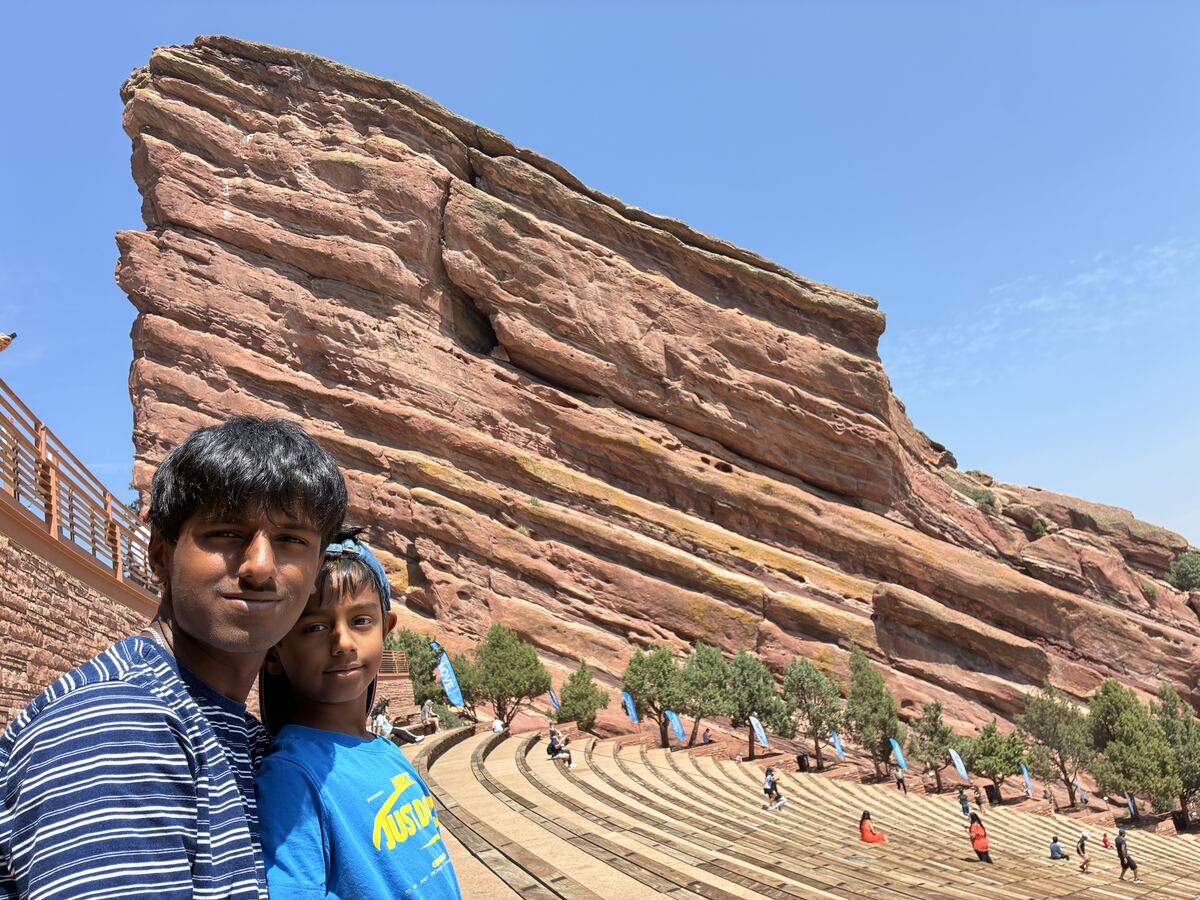 Sanjeeva and Nidhulan taking a selfie in front of a giant red rock formation